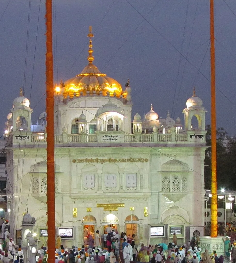 The illuminated golden dome and facade of Takht Sri Hazur Sahib in Nanded at night