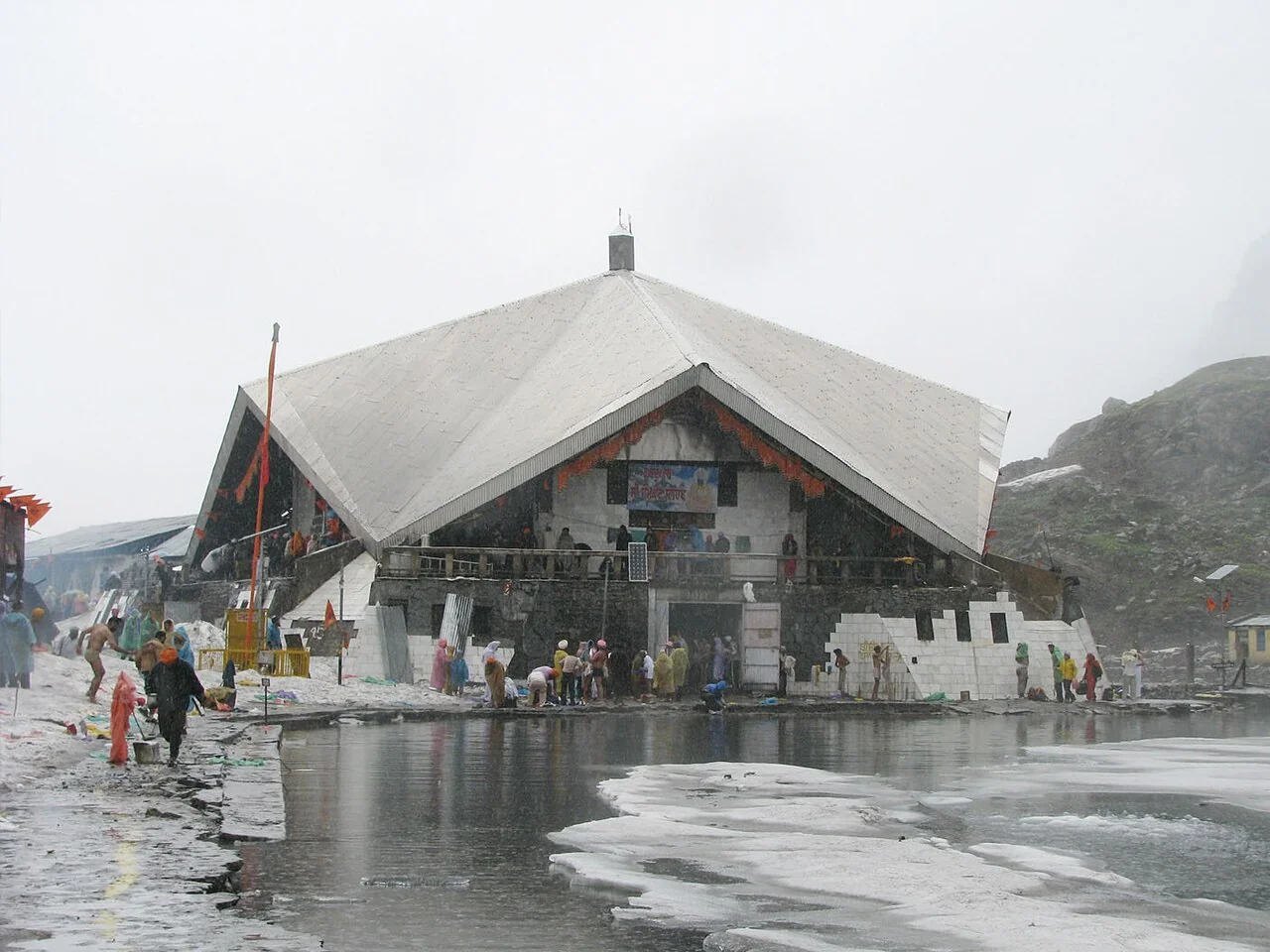 Gurudwara Sri Hemkund Sahib beside the lake, surrounded by mountain mist